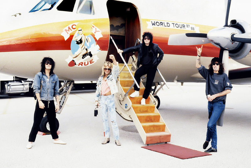 Motley Crue photographed with their private plane during the Girls, Girls, Girls Tour, 1987, by Mark Weiss.