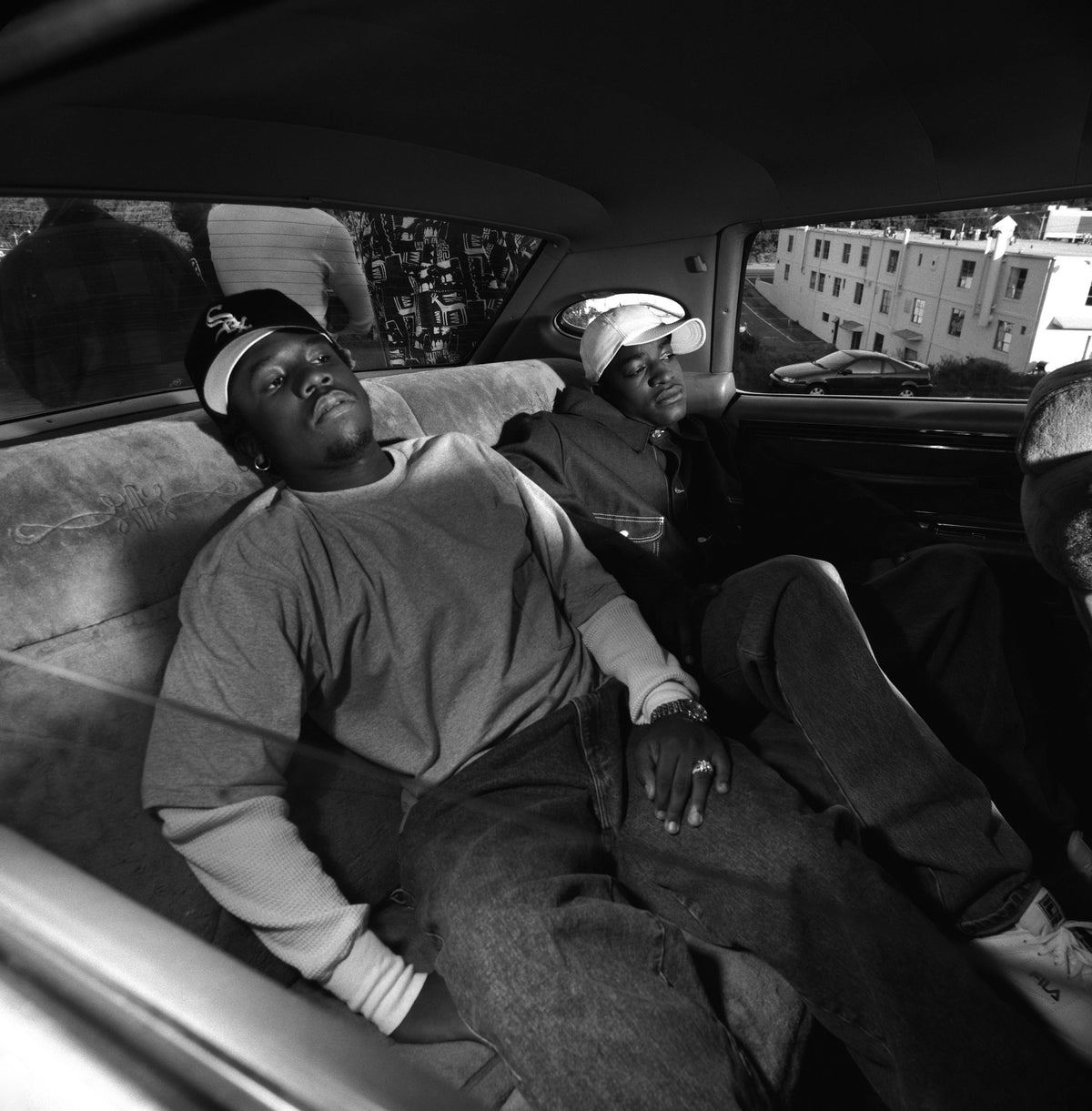 The members of OutKast occupy the back seat of a car in a closely framed interior portrait. Photograph by Timothy White, Atlanta, Georgia, 1993.
