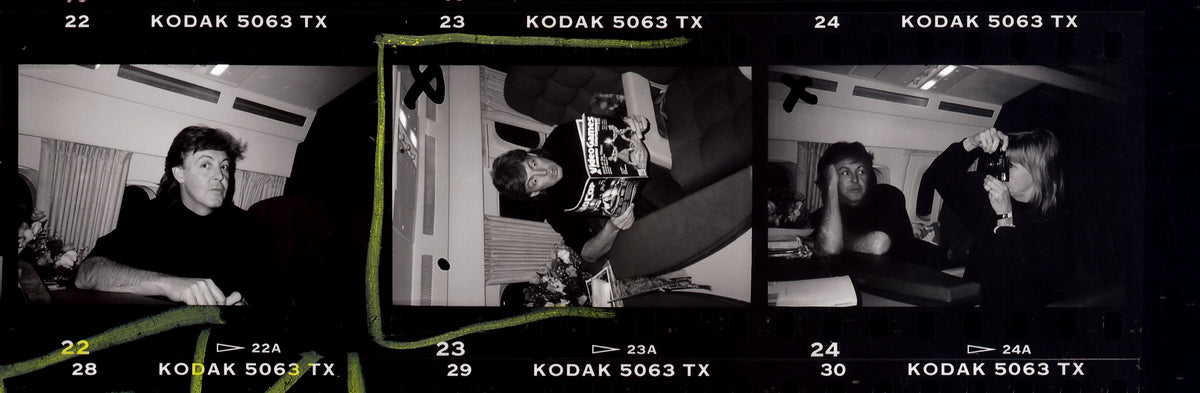 Three consecutive film frames show Paul and Linda McCartney in an informal interior, with film markings visible around the images. Photograph by Timothy White, Toronto, Canada, 1989.