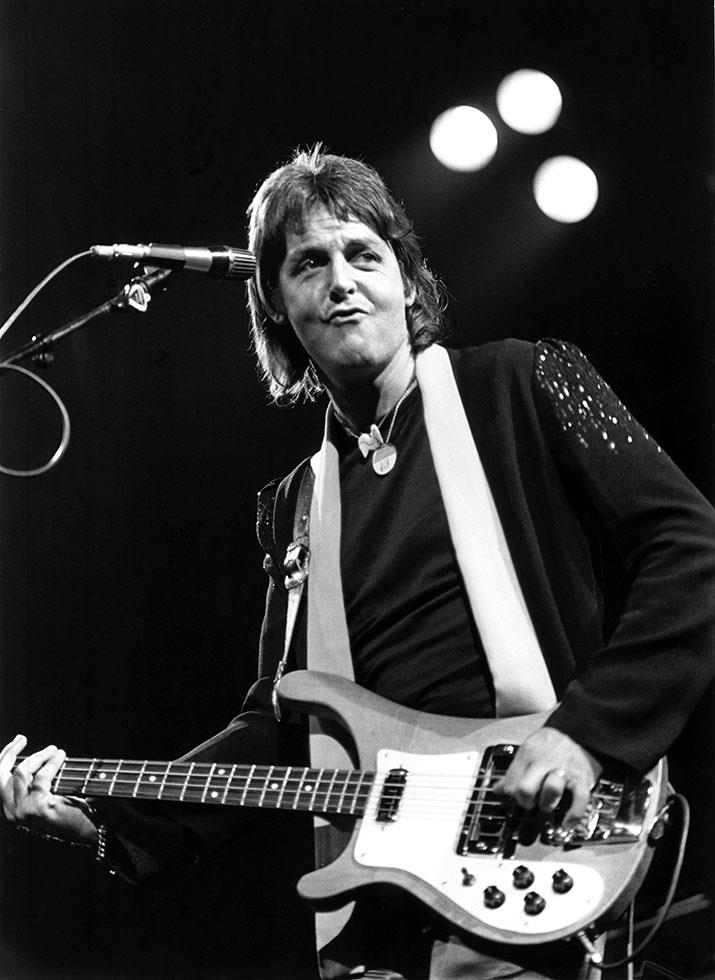 Paul McCartney singing at the microphone with his Rickenbacker bass, photographed by Charlyn Zlotnik.