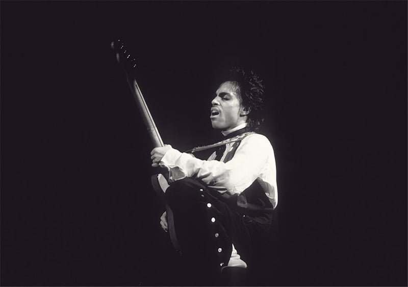 Prince performing with his guitar, photographed by Charlyn Zlotnik, 1981.