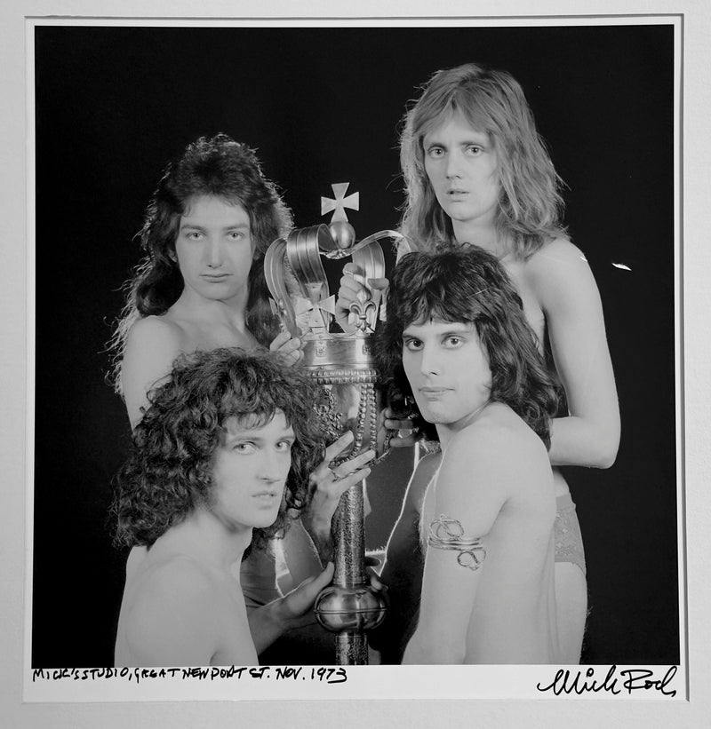 Queen gathered around a ceremonial mace and crown at Mick Rock's studio, Great Newport Street, London, November 1973 — a signed, hand-titled late print.