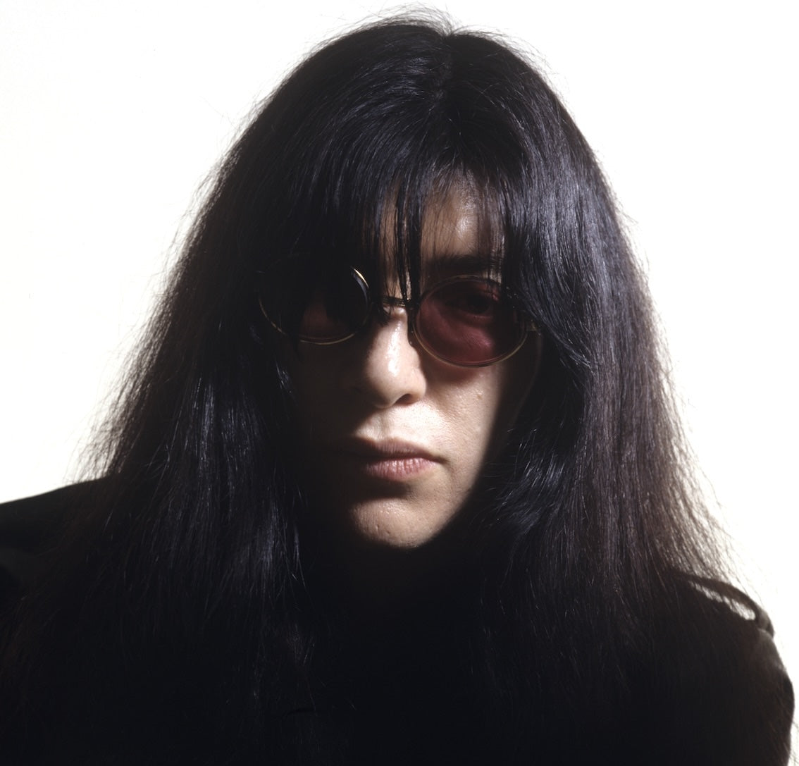 Joey Ramone in sunglasses, studio portrait, New York City, 1984, photographed by George DuBose.