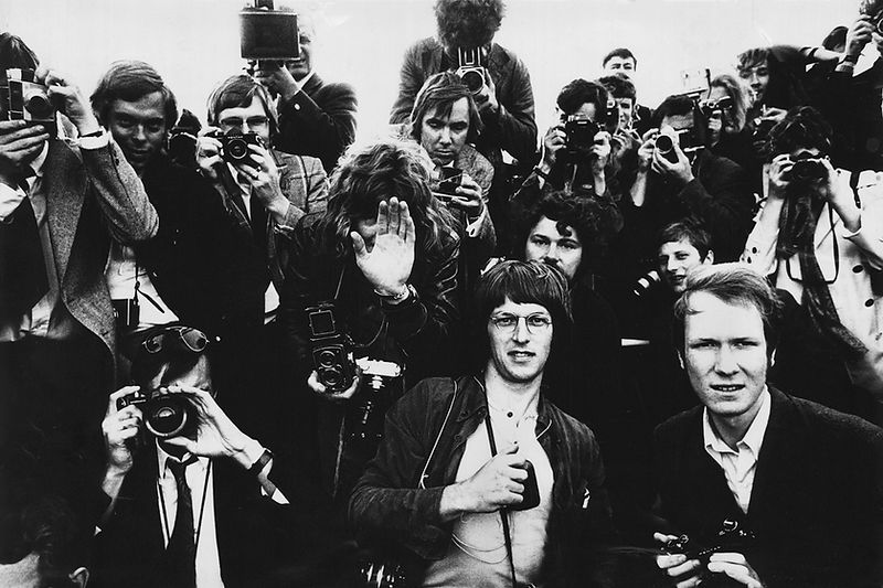 The Rolling Stones surrounded by press photographers in 1970. Photograph by Gijsbert Hanekroot.