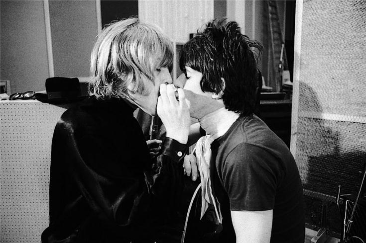 Brian Jones and Keith Richards sharing a blowback at Olympic Studios, London, photographed by Michael Cooper, 1966.