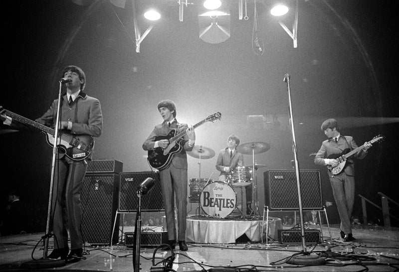 The Beatles performing at their first U.S. concert at Washington Coliseum in 1964, photographed by Rowland Scherman.