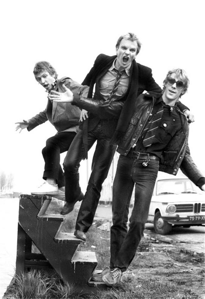 The Police — Sting, Andy Summers and Stewart Copeland — on a staircase in Amsterdam, 1979, photographed by Barry Schultz.