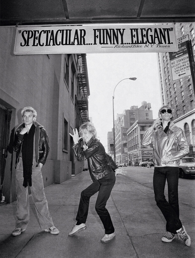 The Police on a sidewalk beneath a theater marquee, in black and white, 1978, photographed by Lynn Goldsmith.