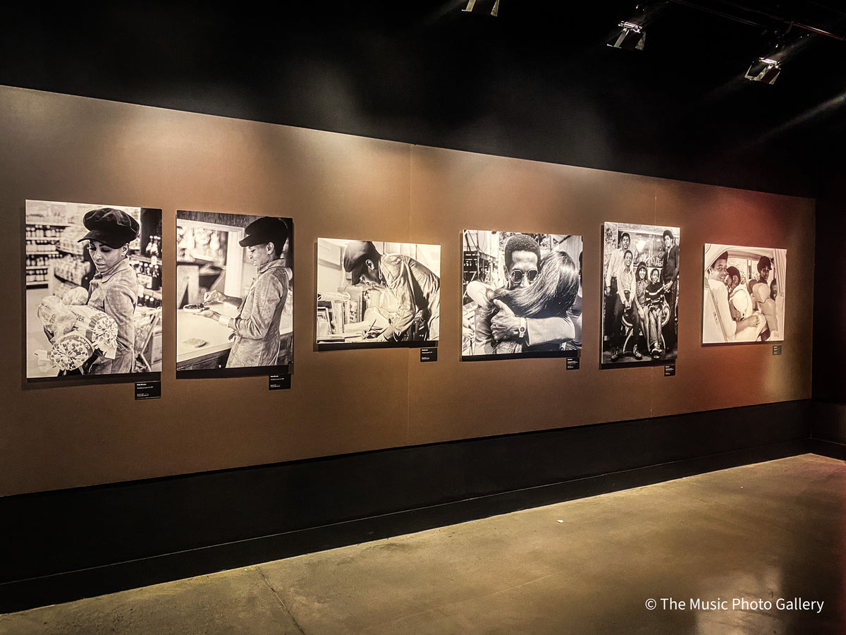 A row of black-and-white photographs of Tina Turner on a dark wall in Tina Turner: A Journey to the Future at the Museum of Image and Sound (MIS), São Paulo, Brazil.