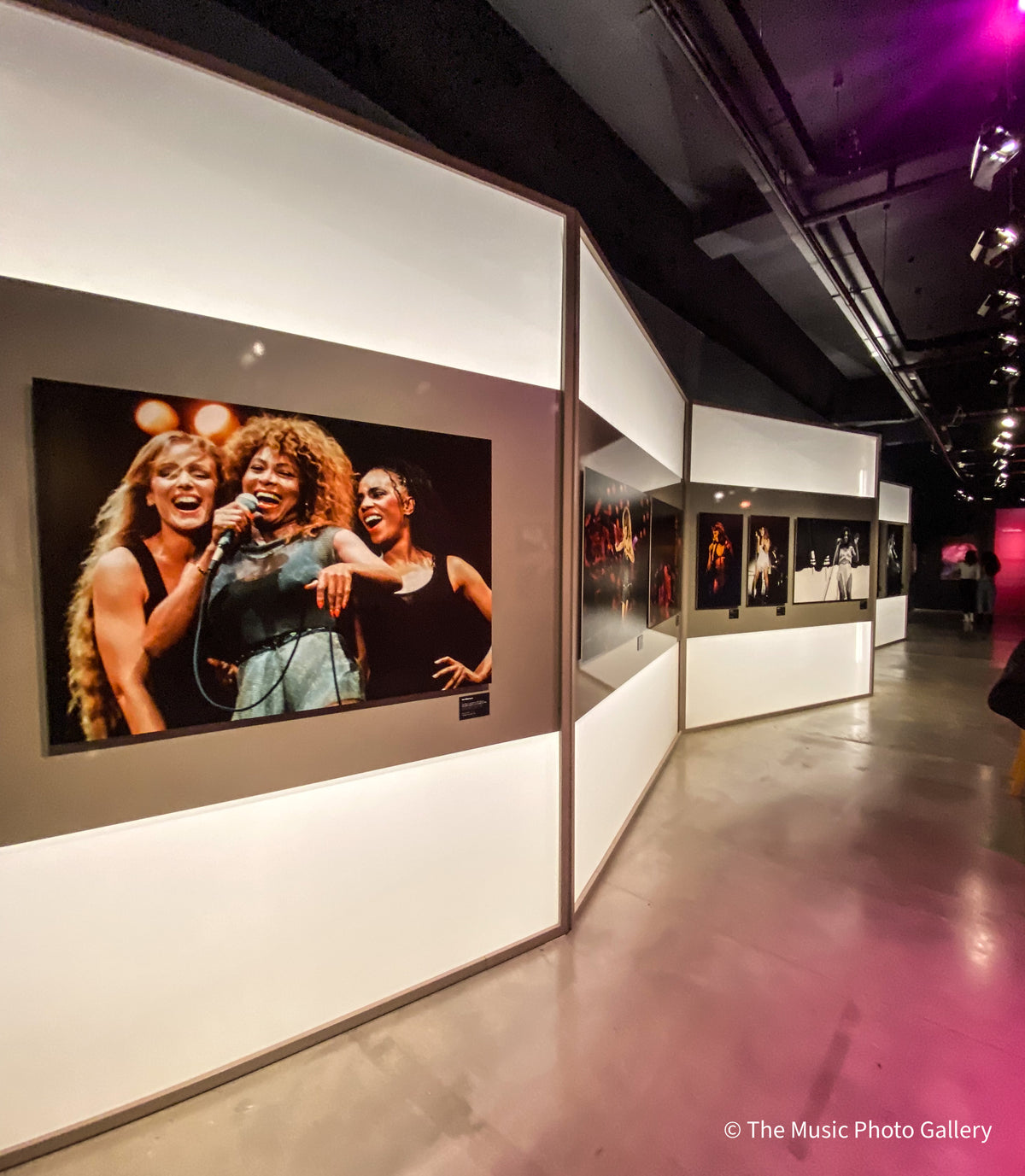 A color concert photograph of Tina Turner on an illuminated display wall in Tina Turner: A Journey to the Future at the Museum of Image and Sound (MIS), São Paulo, Brazil.