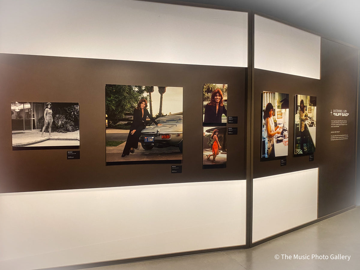 Gallery view with color photographs of Tina Turner on illuminated display walls in Tina Turner: A Journey to the Future at the Museum of Image and Sound (MIS), São Paulo, Brazil.