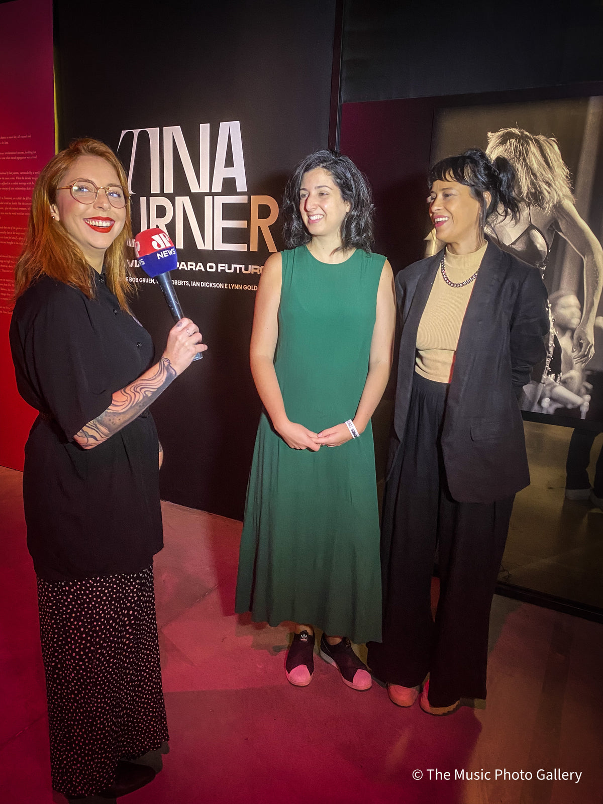 A television interview in front of the title wall in Tina Turner: A Journey to the Future at the Museum of Image and Sound (MIS), São Paulo, Brazil.
