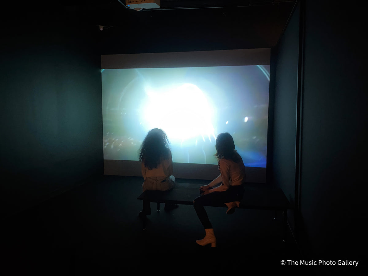 Two visitors seated in the screening room in Tina Turner: A Journey to the Future at the Museum of Image and Sound (MIS), São Paulo, Brazil.