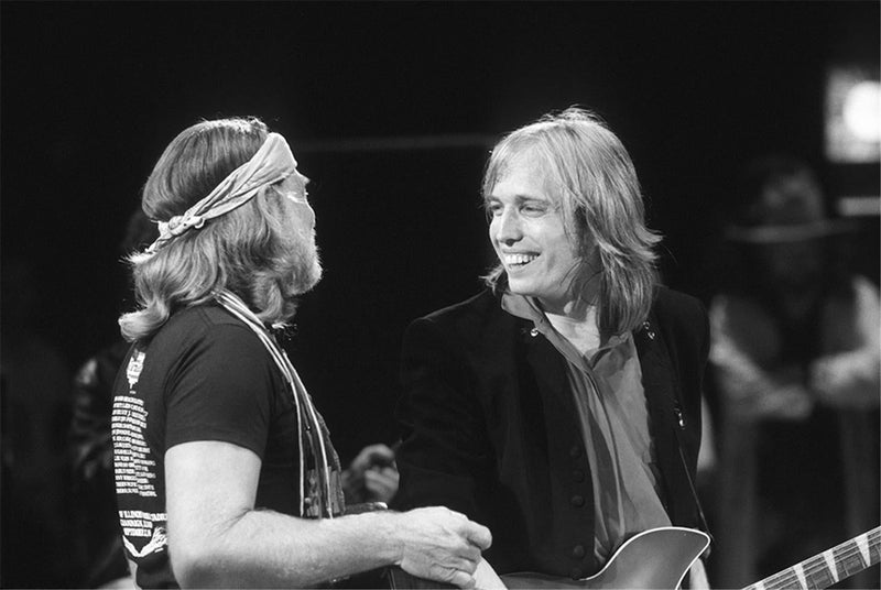 Tom Petty and Willie Nelson performing together at Farm Aid, photographed by Charlyn Zlotnik, 1985.