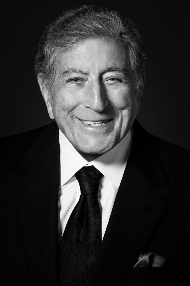 Tony Bennett smiling in a dark suit, in black and white, 2014, photographed by Lynn Goldsmith.